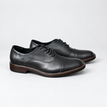 Par de zapatos negros con cordones, vista lateral